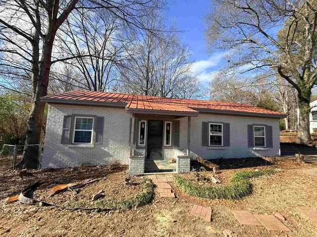a view of a house with a yard covered in snow