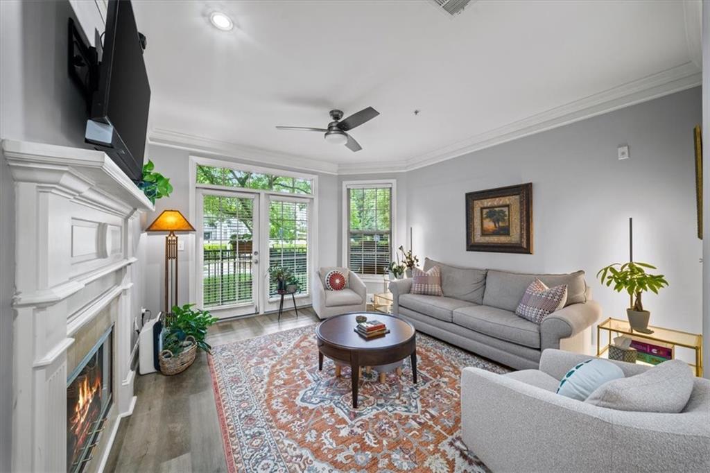 4100 Paces Walk Southeast, Unit 1101 Atlanta, GA 30339 - Photo 6 of 36 a living room with furniture a chandelier and a window