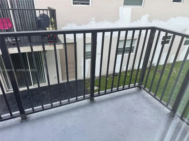a view of a porch with wooden floor