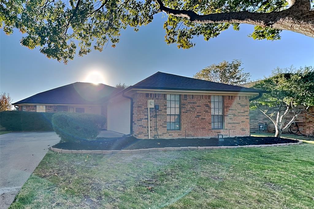 a view of a house with a yard and a garden