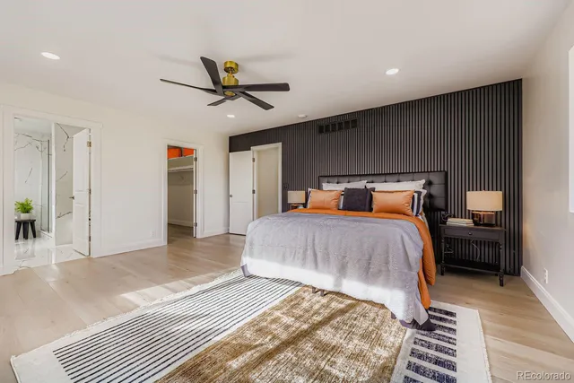 a bedroom with a bed and wooden floor