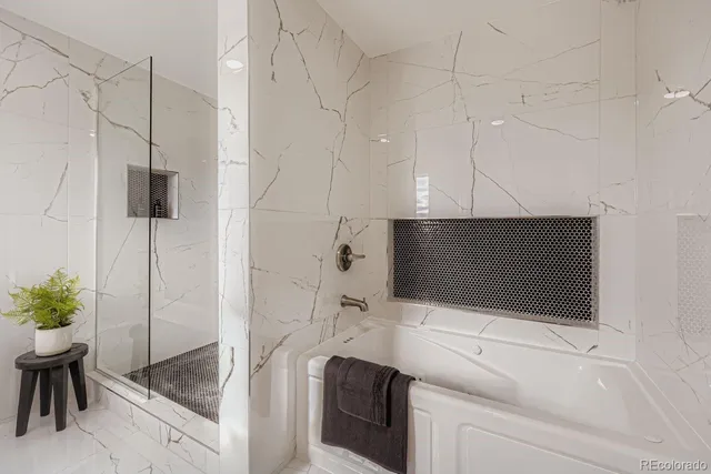 an empty room with wooden floor cabinet and windows