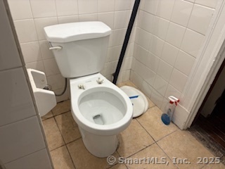 251 Collins Street Hartford, CT 06105 - Photo 11 of 19 a white toilet sitting next to a sink