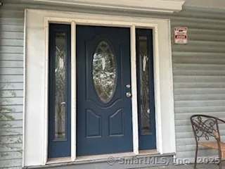 a view of a entryway door front of a house