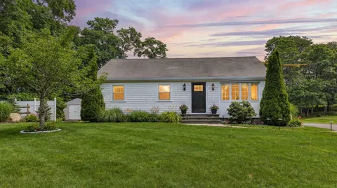 a front view of house with yard and green space