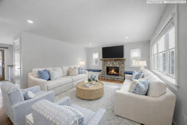 a living room with furniture a fireplace and a flat screen tv