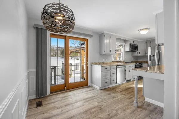 a kitchen with stainless steel appliances granite countertop a stove and cabinets