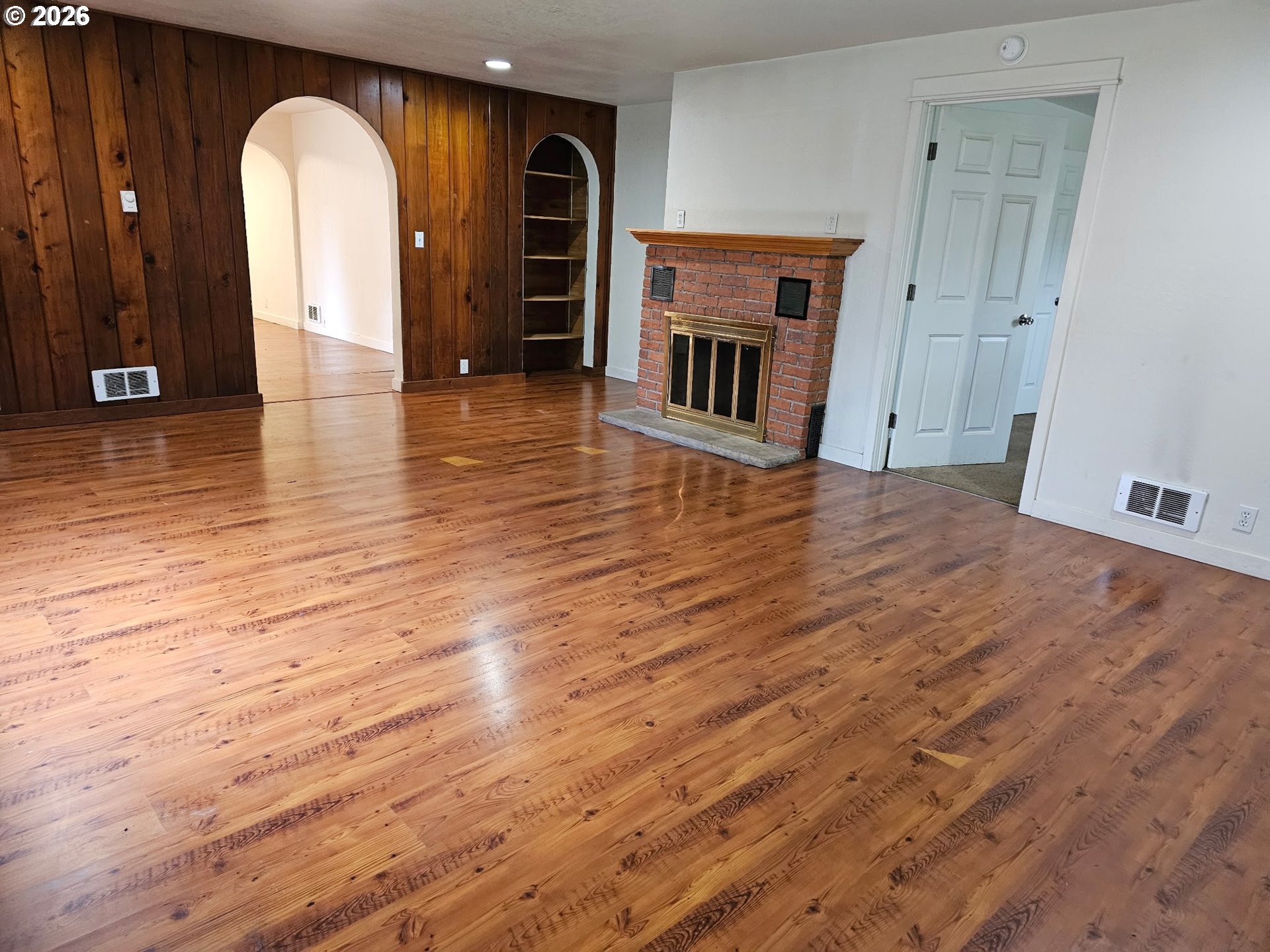 33802 Market Road Creswell, OR 97426 - Photo 5 of 30 a view of empty room with fireplace and wooden floor