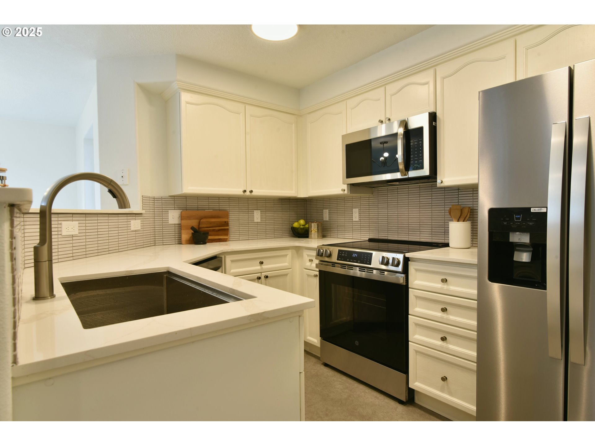 20382 Southwest Monson Street Beaverton, OR 97003 - Photo 12 of 28 a kitchen with stainless steel appliances granite countertop a refrigerator and a stove top oven