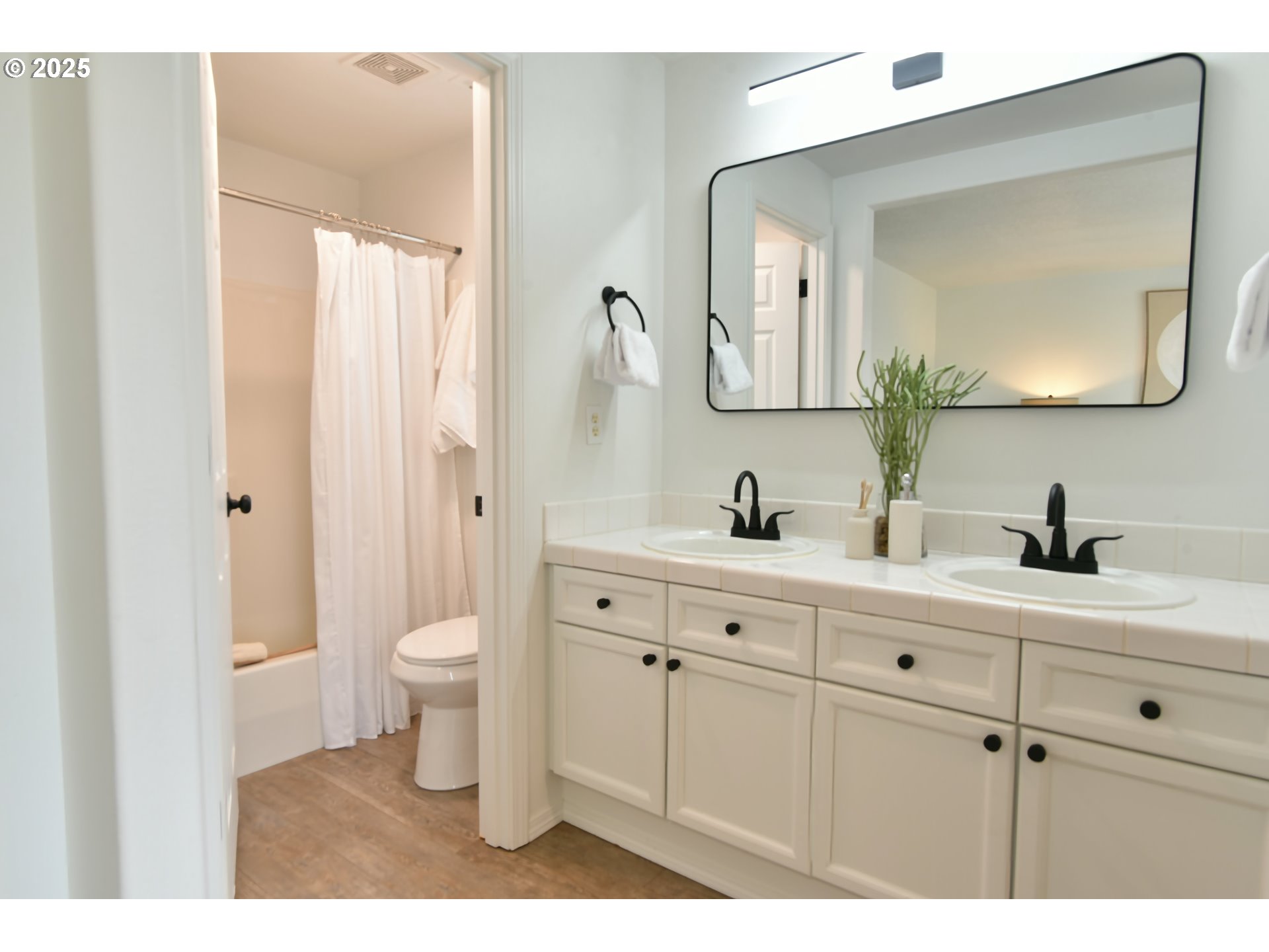 20382 Southwest Monson Street Beaverton, OR 97003 - Photo 20 of 28 a bathroom with a double vanity sink mirror and toilet