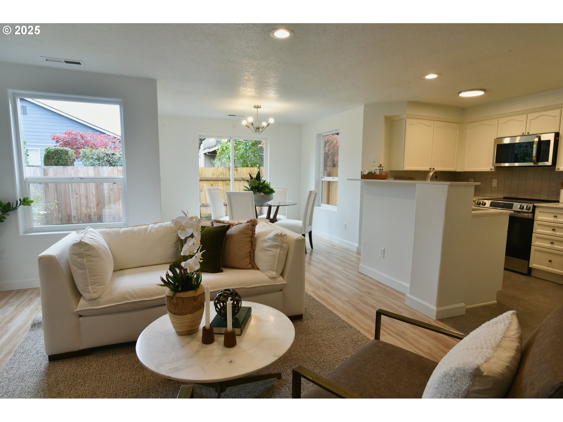 20382 Southwest Monson Street Beaverton, OR 97003 - Photo 10 of 28 a living room with furniture kitchen view and a dining table