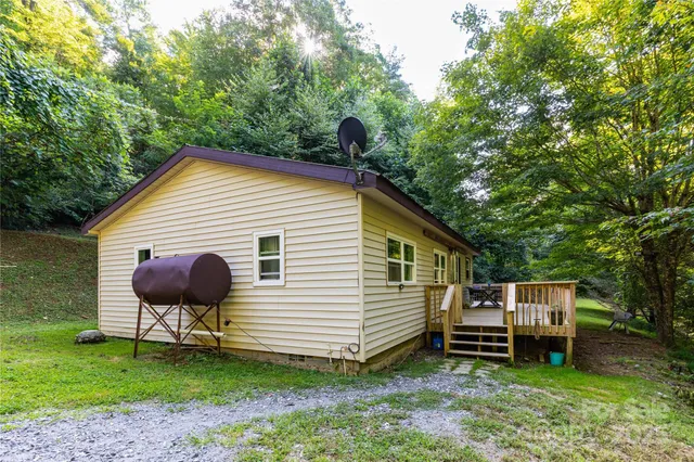 a backyard of a house with table and chairs