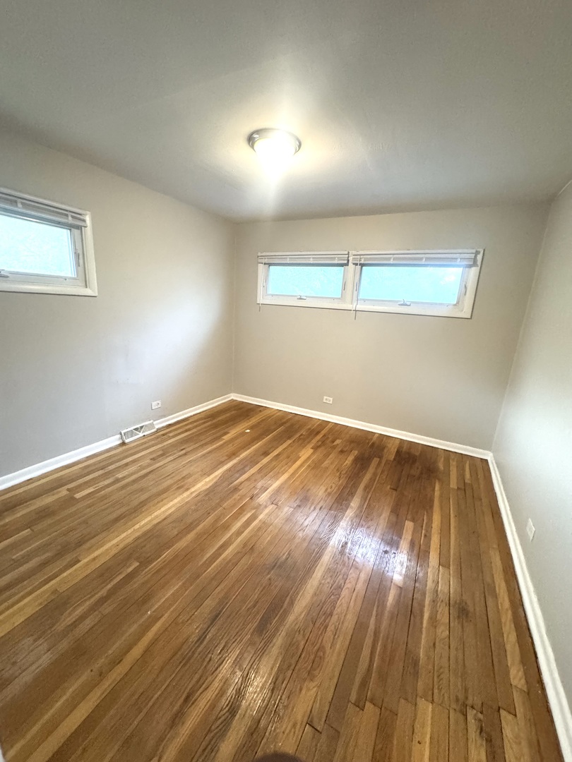 1834 Terrace Road Homewood, IL 60430 - Photo 12 of 21 an empty room with wooden floor and windows