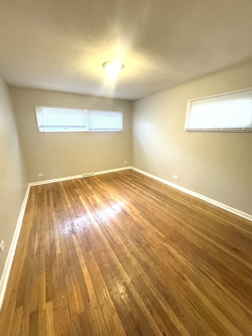 1834 Terrace Road Homewood, IL 60430 - Photo 15 of 21 an empty room with wooden floor and windows