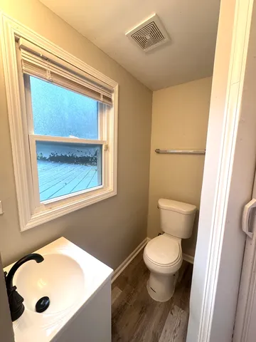 a white toilet sitting next to a bathroom sink