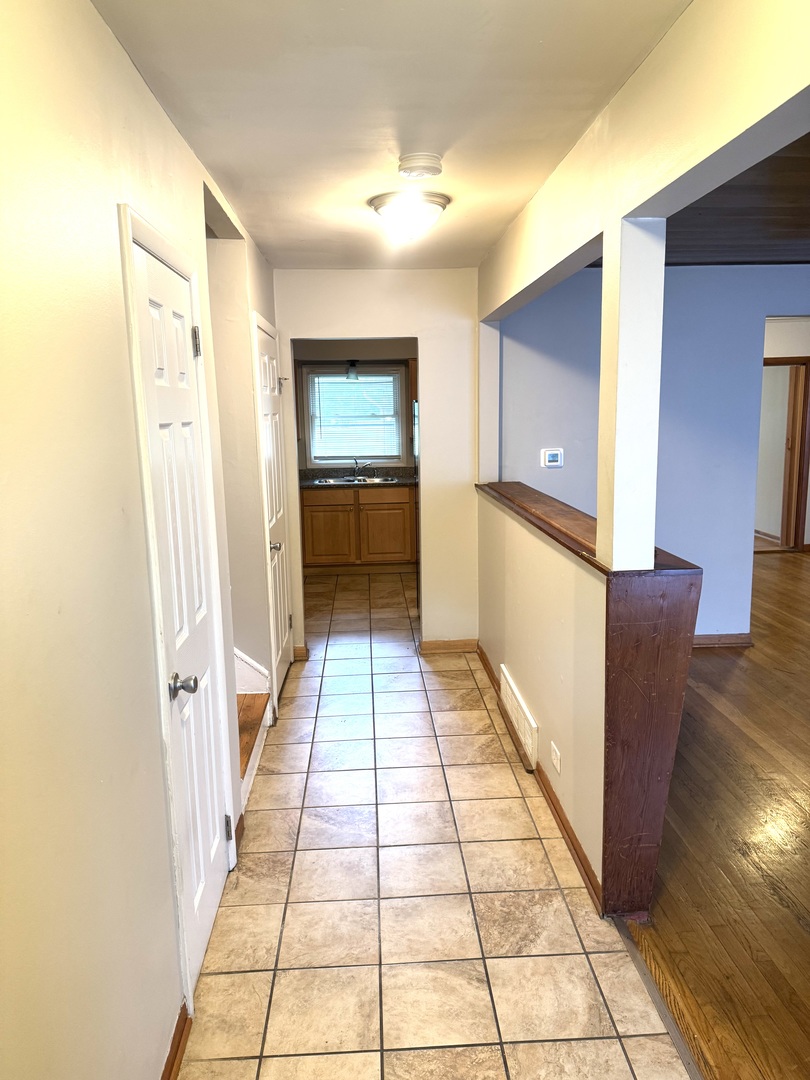 1834 Terrace Road Homewood, IL 60430 - Photo 2 of 21 a hallway with a large mirror and a sink