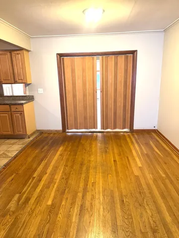 a view of a room with wooden floor and a sink