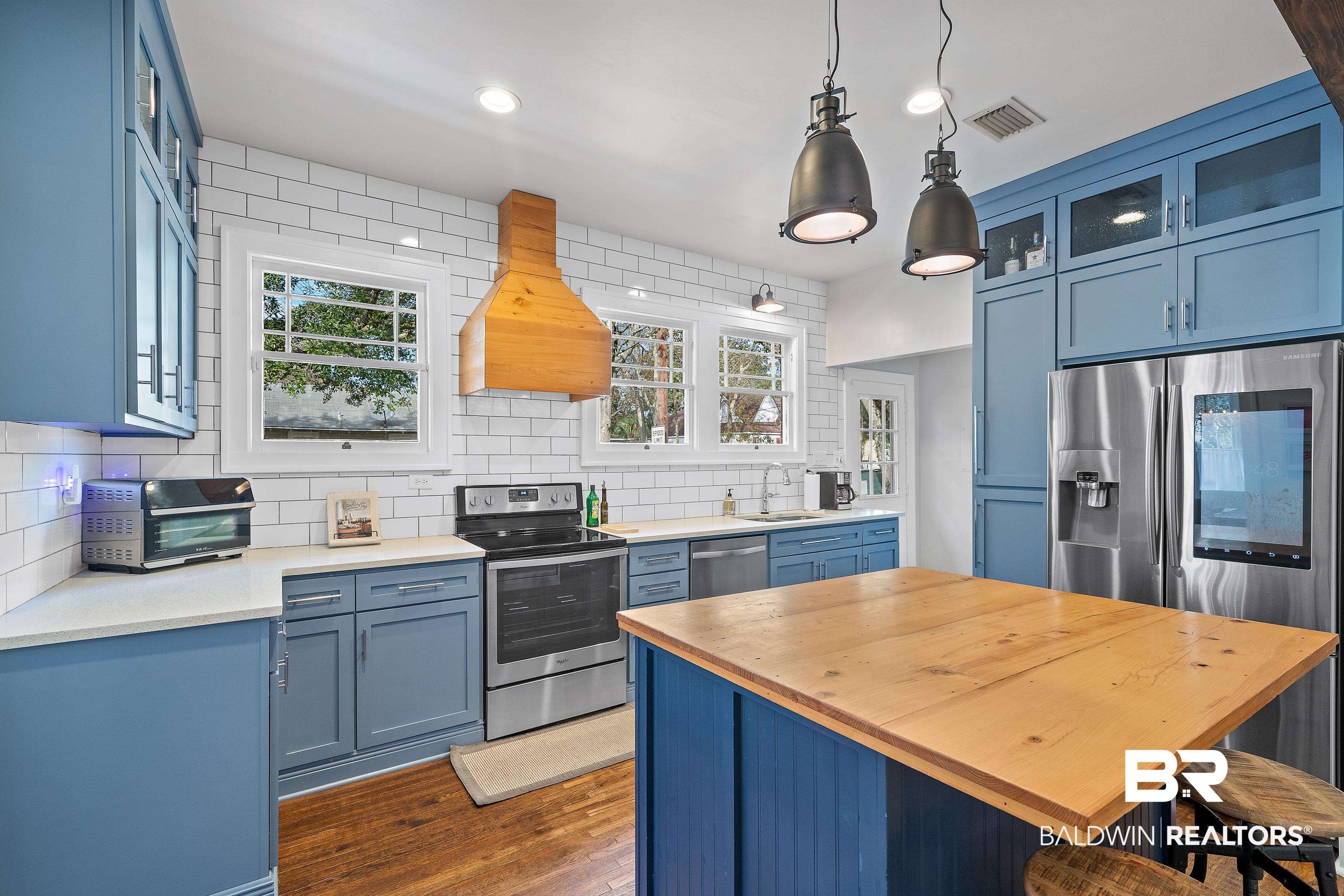 111 Macy Place Mobile, AL 36604 - Photo 13 of 35 The Kitchen also features pendant lighting and a custom exhaust hood.