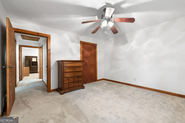 a bathroom with a toilet a sink a vanity and mirror