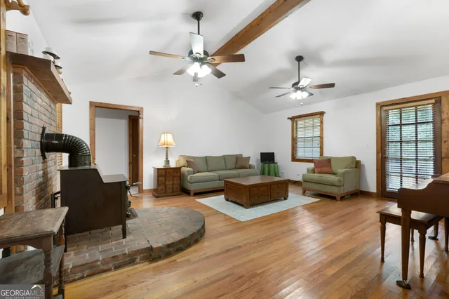 a living room with fireplace furniture and a chandelier