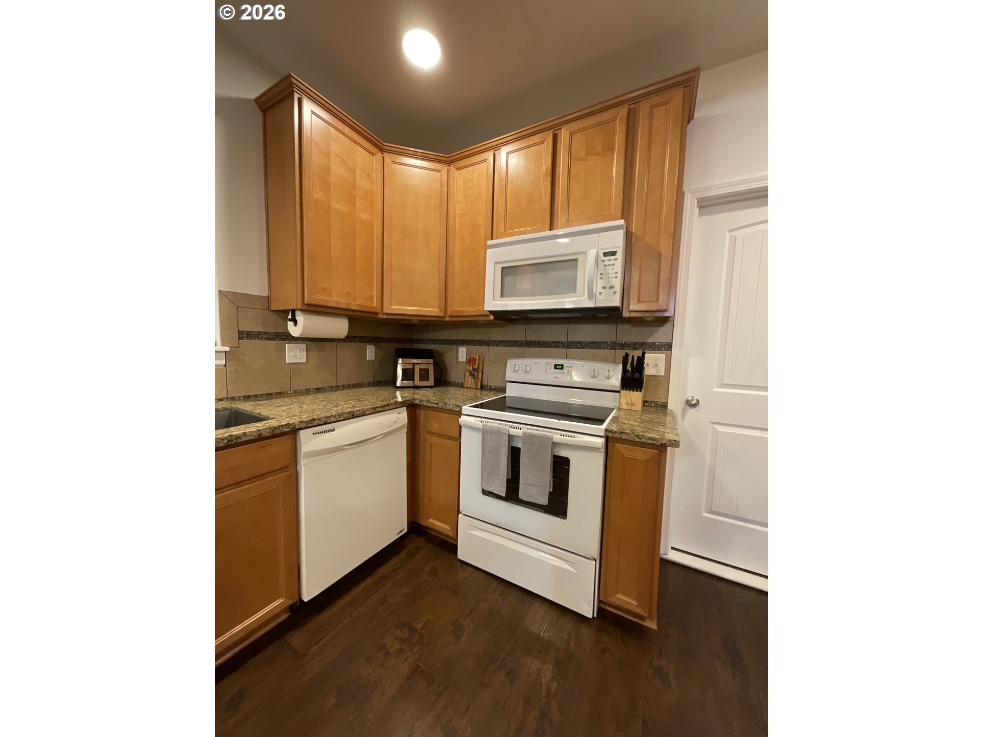 1310 Gales Creek Road Forest Grove, OR 97116 - Photo 16 of 39 a kitchen with stainless steel appliances a stove a microwave a sink and cabinets