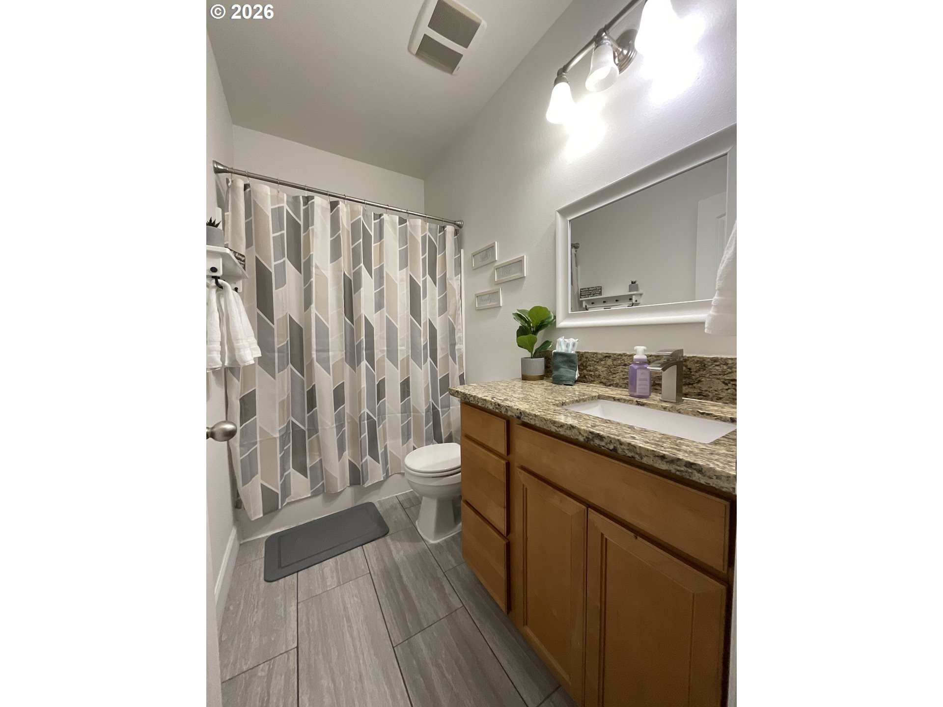 1310 Gales Creek Road Forest Grove, OR 97116 - Photo 17 of 39 a bathroom with a granite countertop sink toilet and shower curtains