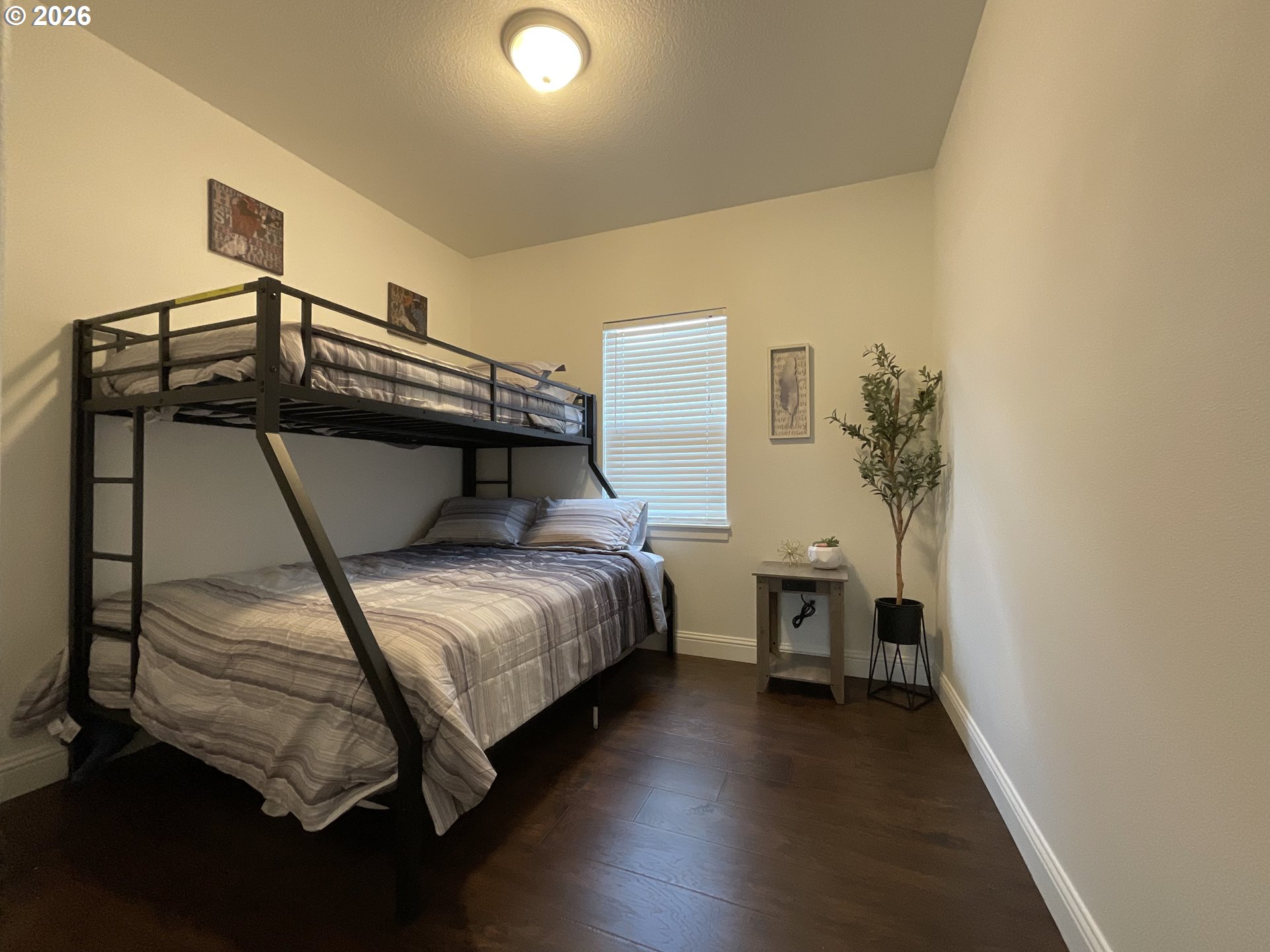 1310 Gales Creek Road Forest Grove, OR 97116 - Photo 21 of 39 a bedroom with a bed and a chandelier