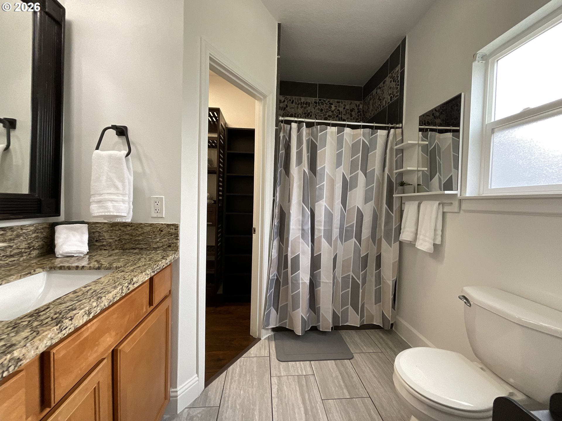 1310 Gales Creek Road Forest Grove, OR 97116 - Photo 25 of 39 a bathroom with a granite countertop sink toilet and shower