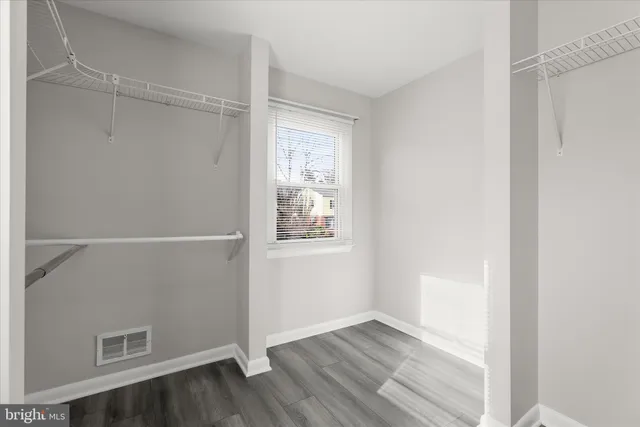 a view of empty room with wooden floor