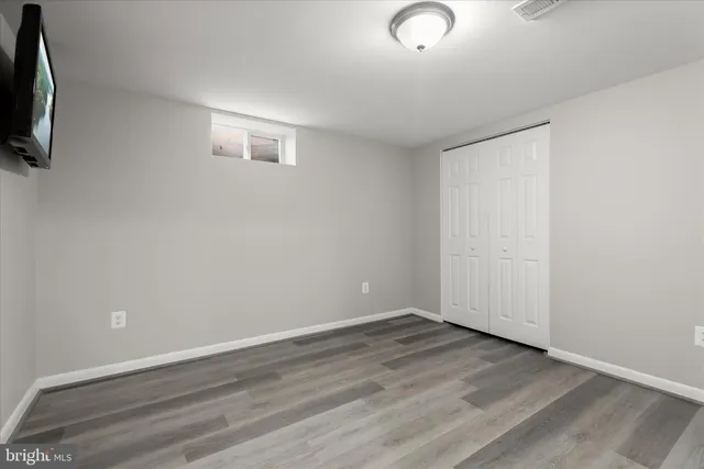 a view of a dining room with furniture large windows and wooden floor