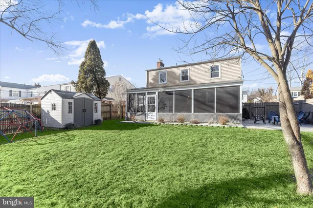a view of a house with a yard and sitting area