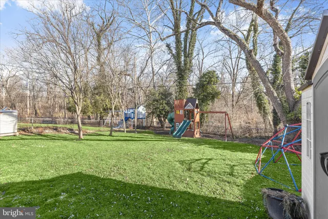 a backyard of a house with barbeque oven table and chairs