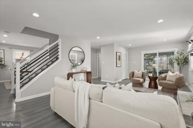 a living room with furniture a mirror and a large window