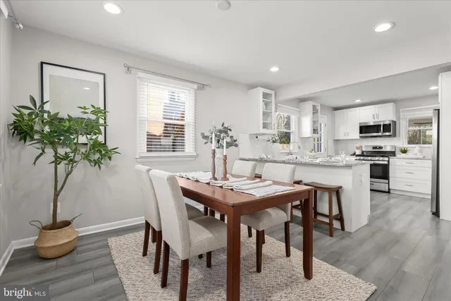 a view of a dining room with furniture and wooden floor