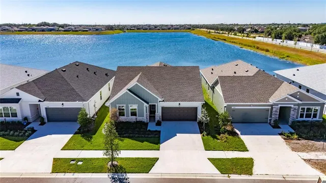 an aerial view of a house with swimming pool yard and outdoor seating