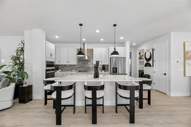 a living room with furniture a piano and wooden floor