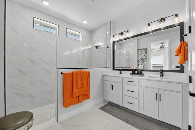 a bedroom with a bed and a ceiling fan