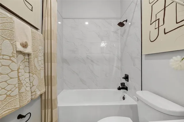 an aerial view of a house with a yard swimming pool and outdoor seating