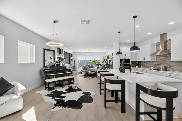 a kitchen with stainless steel appliances granite countertop a refrigerator a sink and a stove