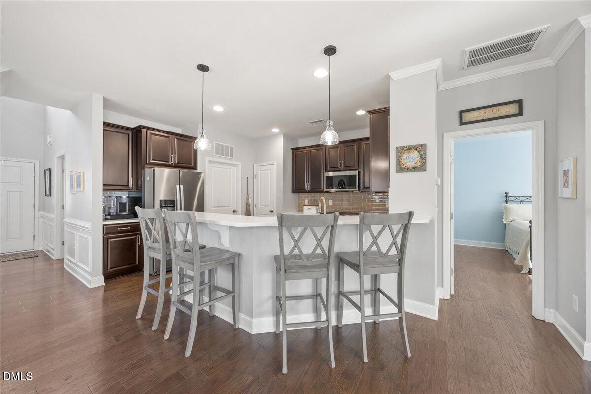 216 Mayfield Drive Apex, NC 27539 - Photo 14 of 66 a view of a dining room with furniture and wooden floor