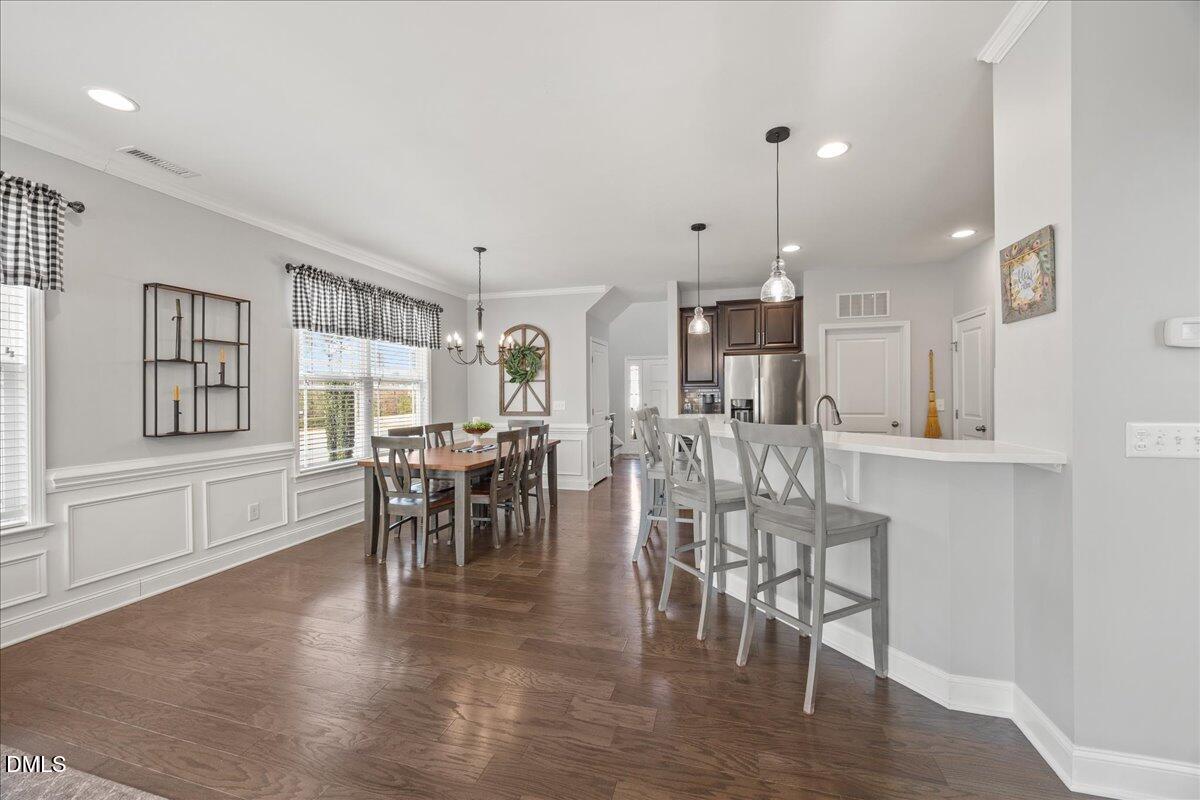 216 Mayfield Drive Apex, NC 27539 - Photo 15 of 66 a dining room with furniture and wooden floor