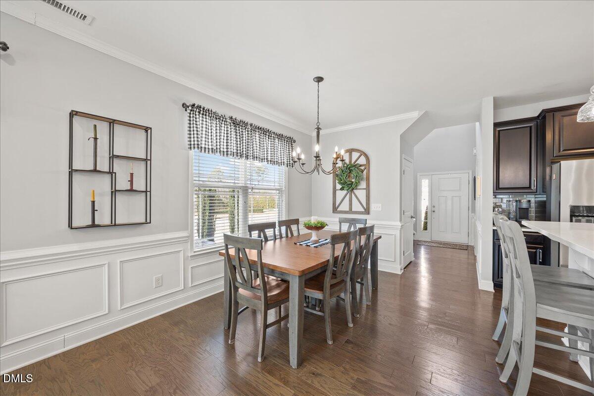216 Mayfield Drive Apex, NC 27539 - Photo 16 of 66 a view of a dining room with furniture window and wooden floor