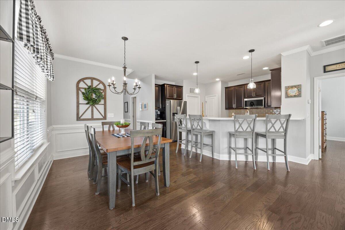 216 Mayfield Drive Apex, NC 27539 - Photo 17 of 66 a view of a dining room with furniture window and wooden floor