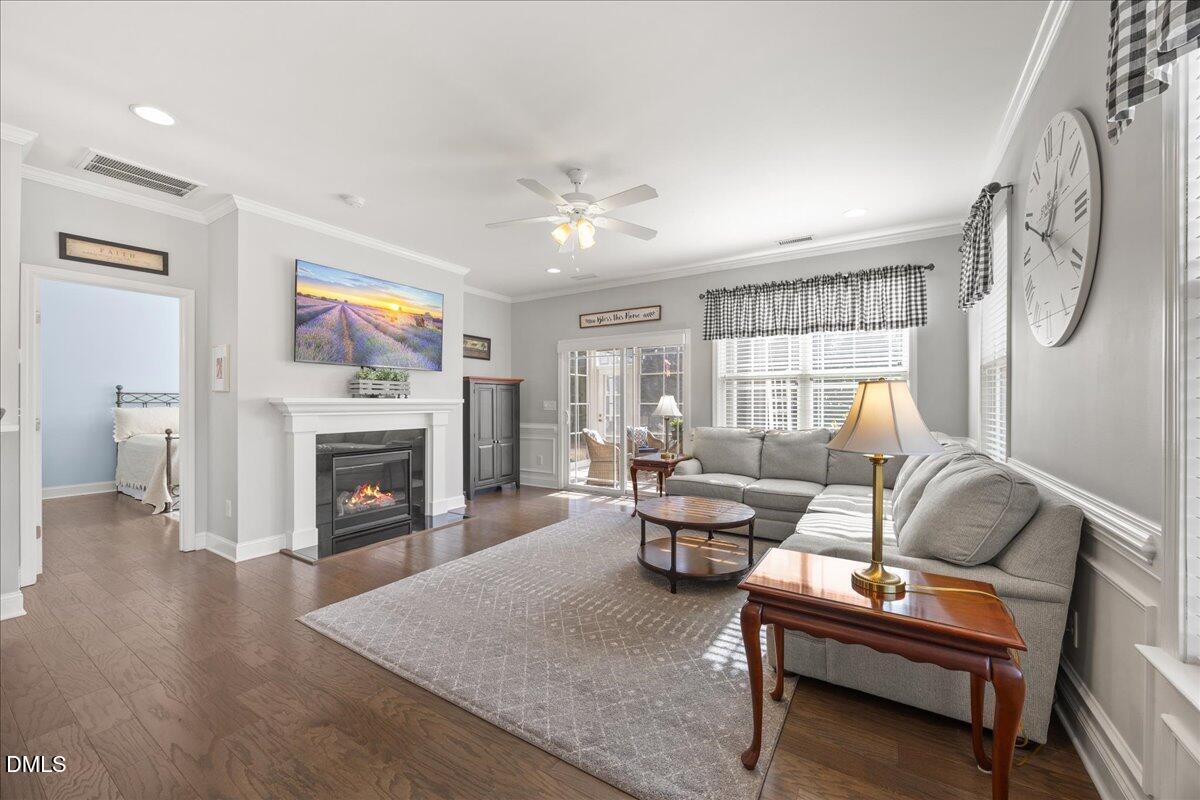 216 Mayfield Drive Apex, NC 27539 - Photo 19 of 66 a living room with furniture a flat screen tv and a fireplace