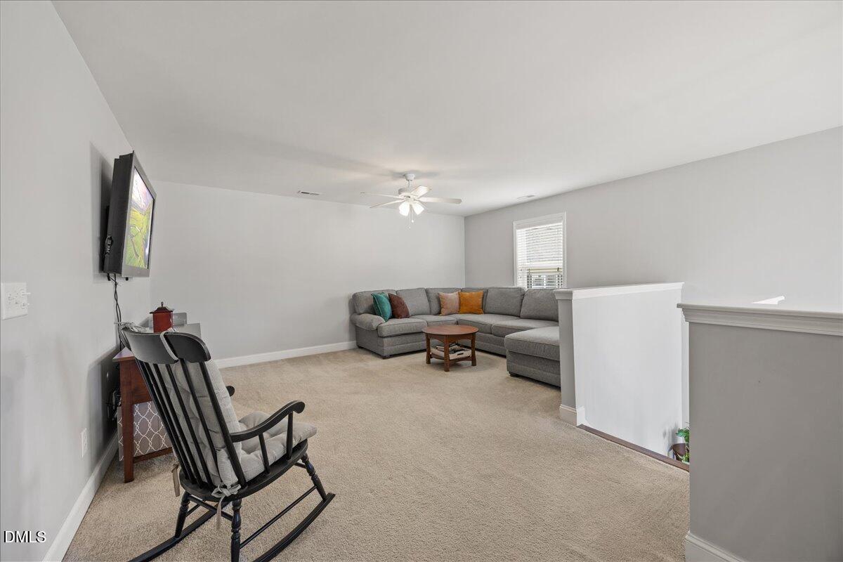 216 Mayfield Drive Apex, NC 27539 - Photo 30 of 66 a living room with furniture and a flat screen tv