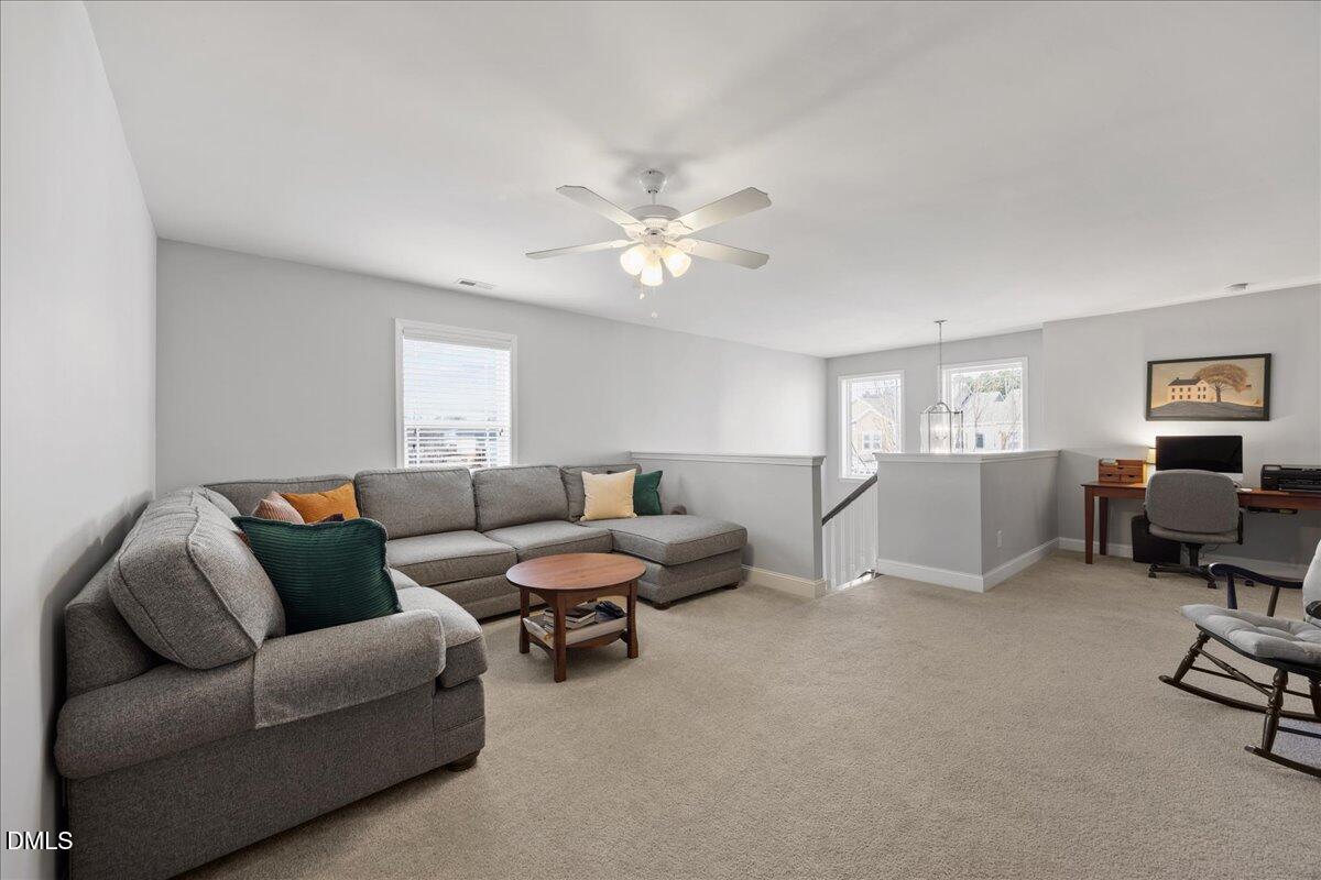 216 Mayfield Drive Apex, NC 27539 - Photo 31 of 66 a living room with furniture and a ceiling fan