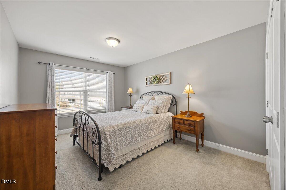 216 Mayfield Drive Apex, NC 27539 - Photo 33 of 66 a bed room with a bed and a window