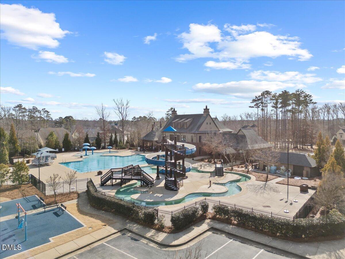 216 Mayfield Drive Apex, NC 27539 - Photo 51 of 66 a view of a swimming pool with a patio and a yard