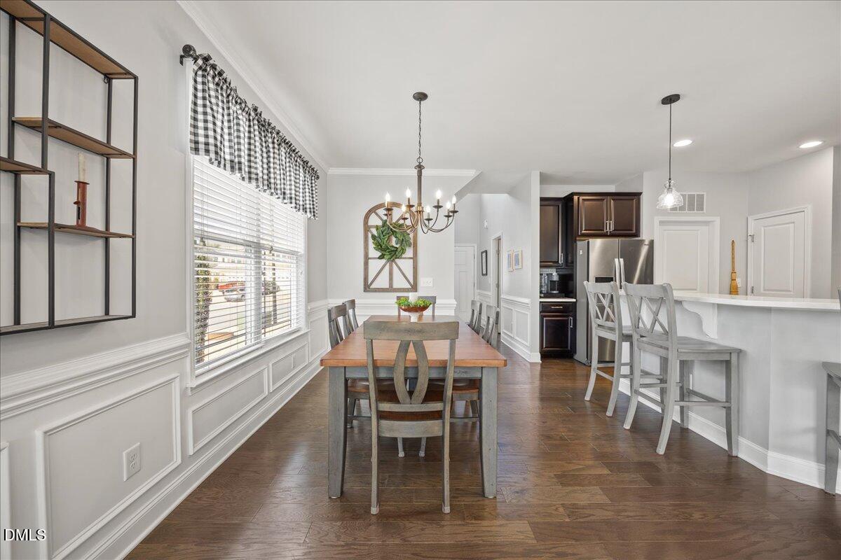 216 Mayfield Drive Apex, NC 27539 - Photo 5 of 66 a dining room with furniture a chandelier and wooden floor