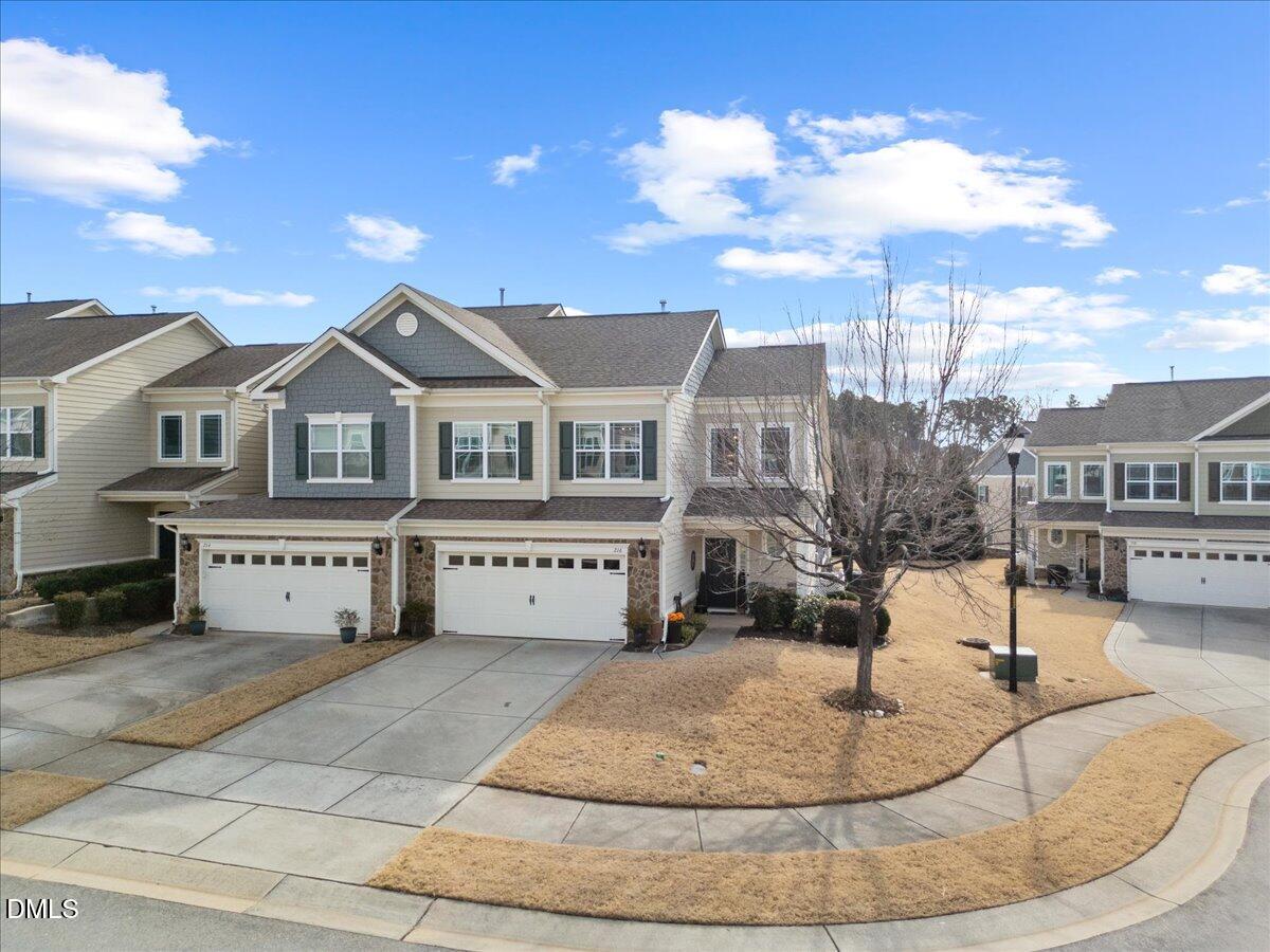 216 Mayfield Drive Apex, NC 27539 - Photo 64 of 66 a view of a white house with a yard in front of it